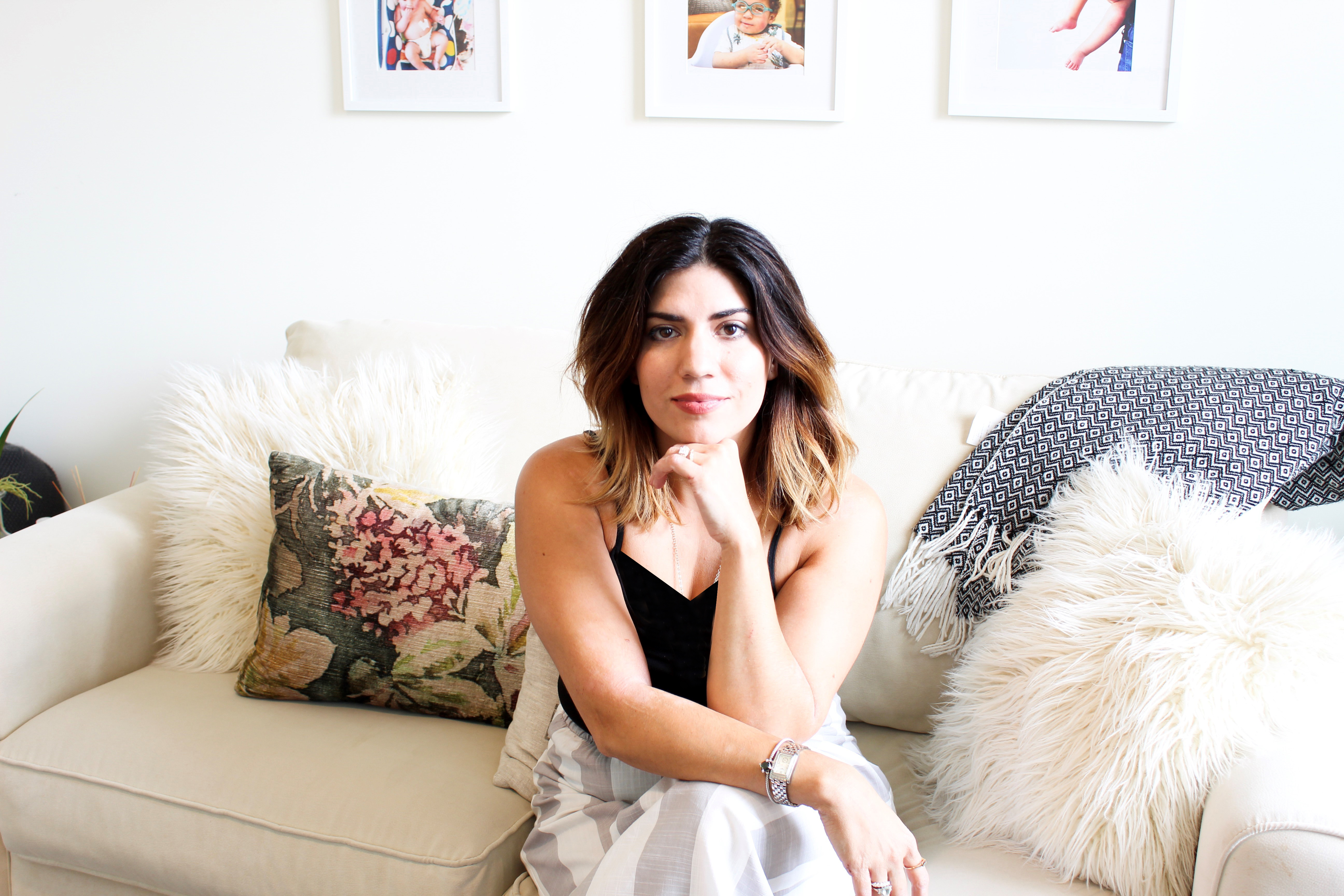 A women sitting on a couch and smiling 