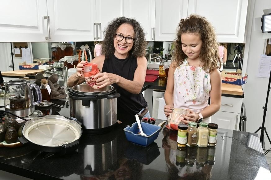 Adita cooking with her daughter