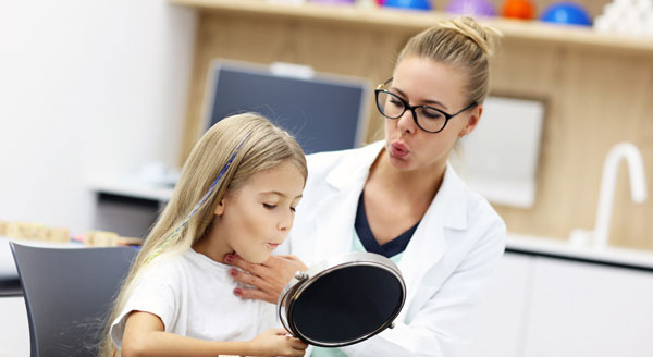 speech therapist helping a girl