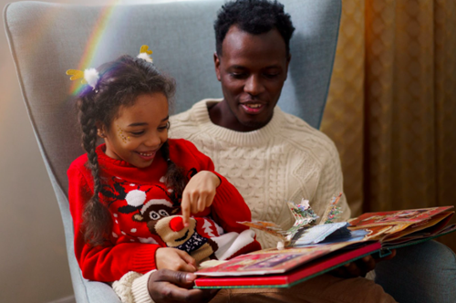 Dad reading a book with his daughter