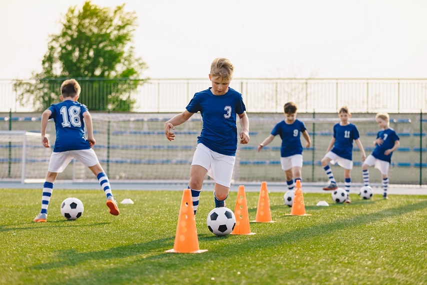 Team of boy soccer players practicing drills