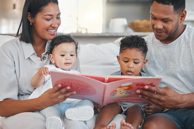 Mom and dad reading to their two small children