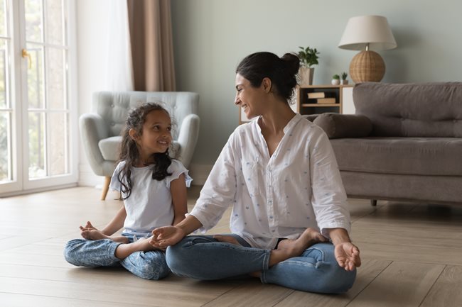 Mom and daughter meditation pose