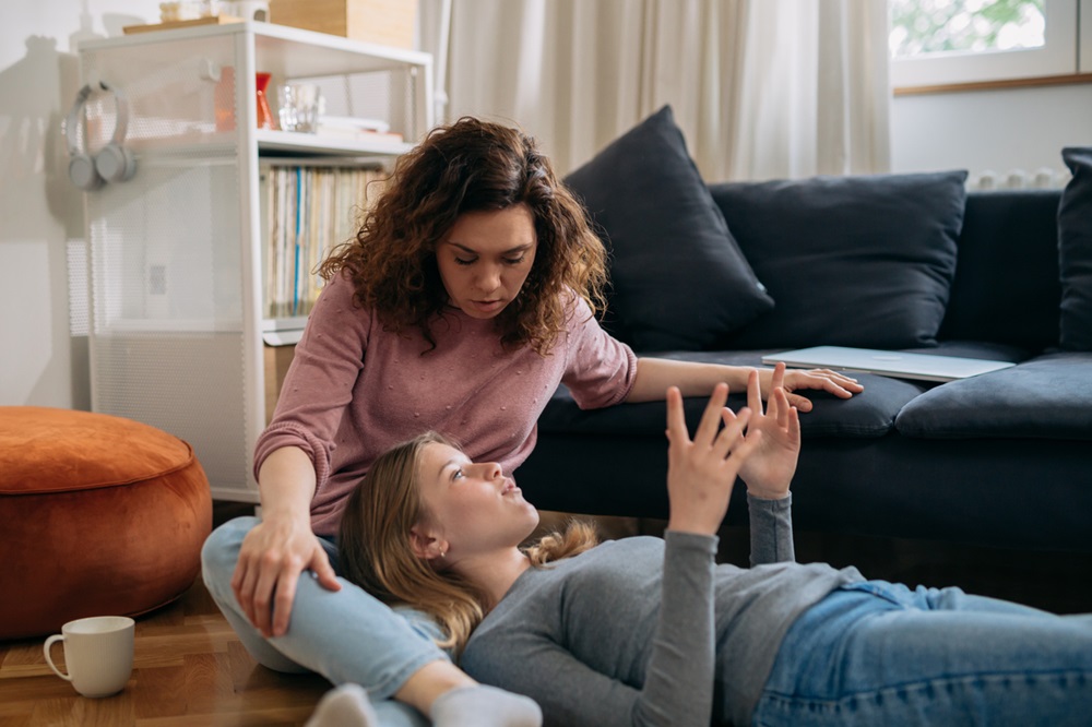 Daughter lying on mom's lap, talking