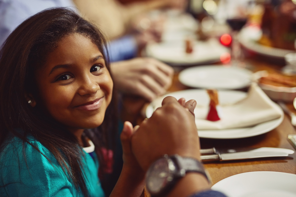 Girl holding hand at table for the holiday