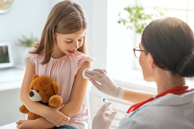 Young girl receiving vaccination shot