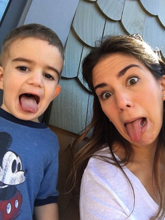 Mother and son sticking their tongues out while smiling 