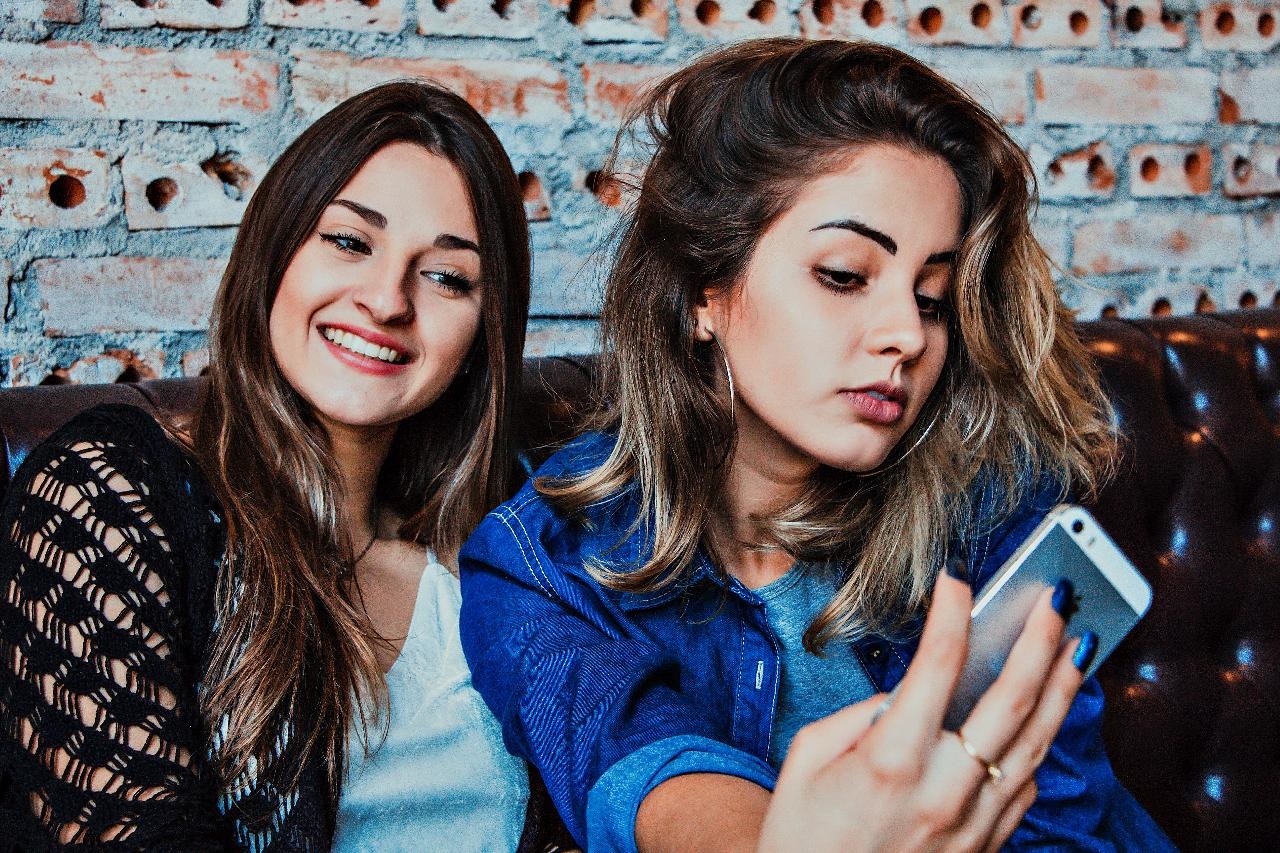 Two smiling women taking a selfie 