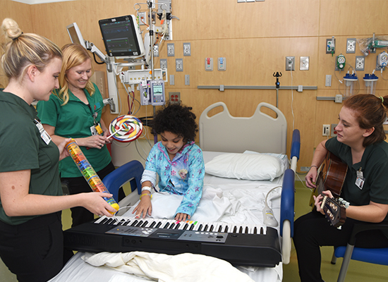 Girl playing electric keyboard from her hospital bed