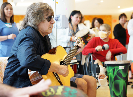 Jose Feliciano playing guitar for patients