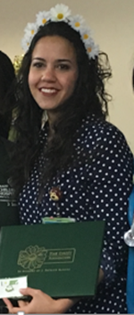 awardee wearing a headband of daisies, daisy award statue, and certificate.