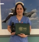 awardee wearing a headband of daisies, daisy award statue, and certificate.