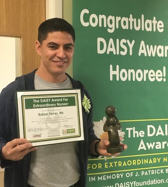 awardee wearing a headband of daisies, daisy award statue, and certificate.