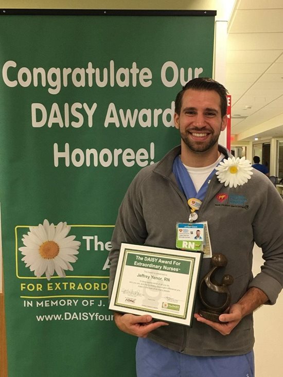 awardee wearing a headband of daisies, daisy award statue, and certificate.