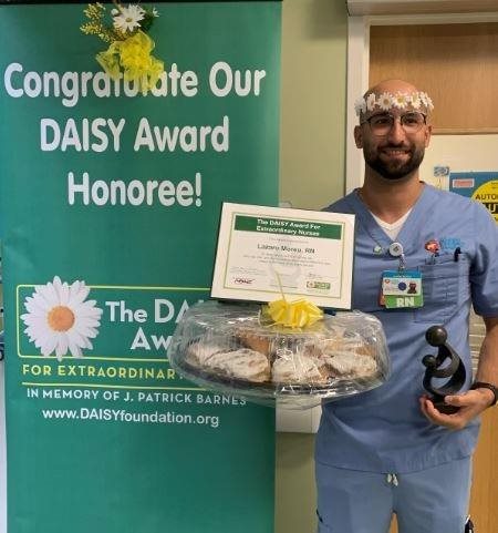 awardee wearing a headband of daisies, daisy award statue, and certificate.