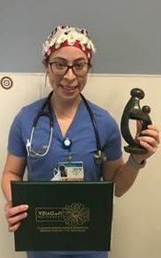 awardee wearing a headband of daisies, daisy award statue, and certificate.