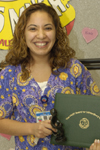 awardee wearing a headband of daisies, daisy award statue, and certificate.