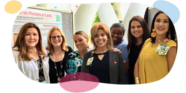 smiling nurses of diverse backgrounds during an education fair