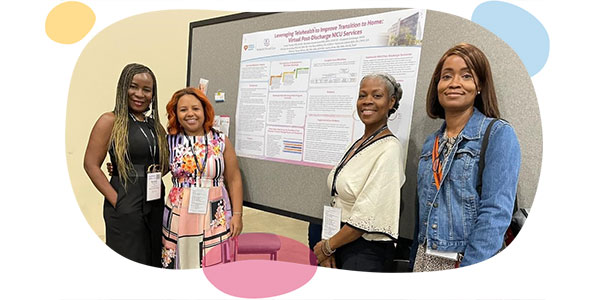 african american nurses posing next to presentation poster.