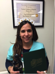 awardee wearing a headband of daisies, daisy award statue, and certificate.