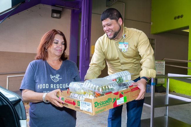 Alejandro Martinez, Manager Retail Operations at Nicklaus Children’s Hospital, hands off rescued foo