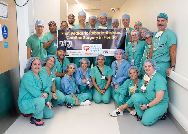 group photo team of cardiac surgeons in green scrubs.