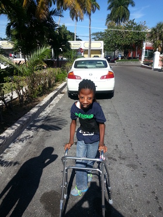 Gerard using a walker while he walks down a street. 