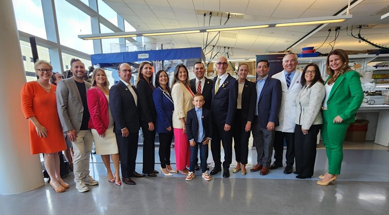 Group photo of FIU and Nicklaus Children's teams with patient family