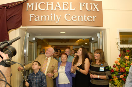 Mr. Fux and community members unveiling the new center.