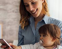 mother with baby checking her smartphone.