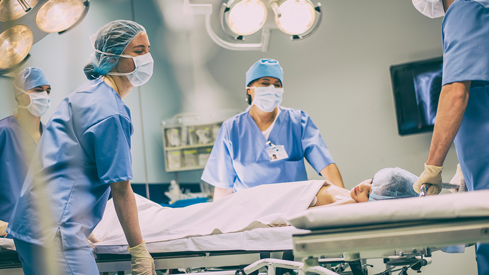 critical care doctors wheeling a patient.