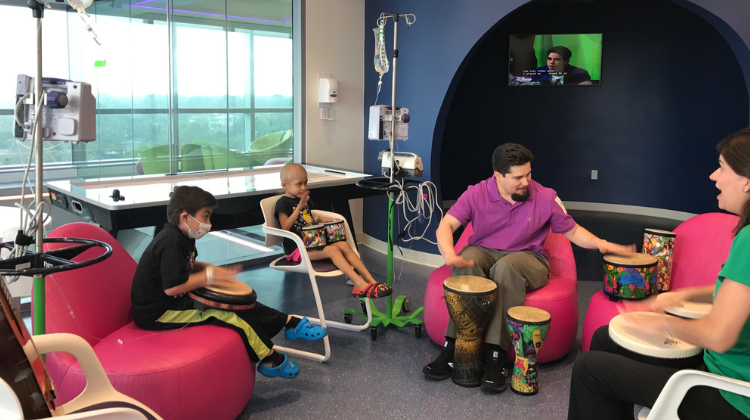 child life specialists engaging in an activity with patients.