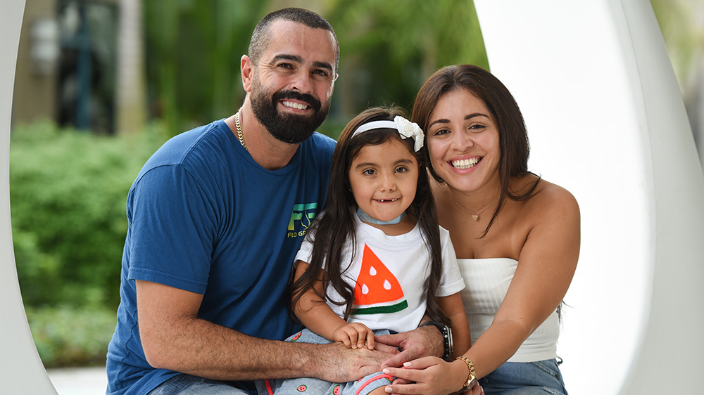 Victoria with her mother and father after her trach tube removal surgery