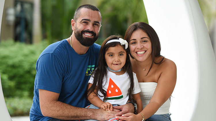 Victoria with her mother and father after her trach tube removal surgery