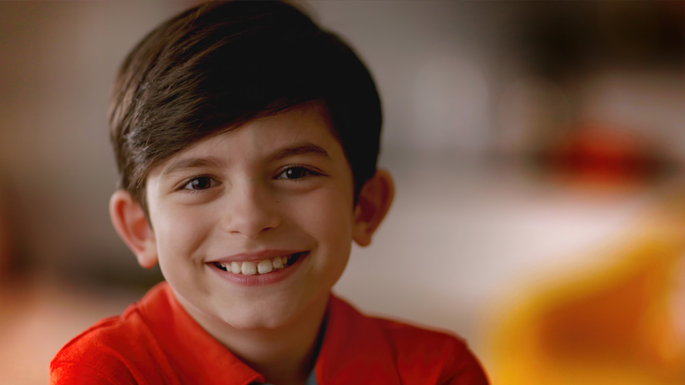 David, a patient with epilepsy, smiles for the camera. click to watch video.