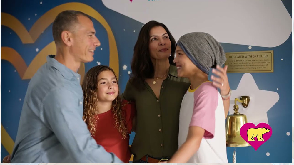 A girl patient hugs her family on the last day of her cancer treatment.