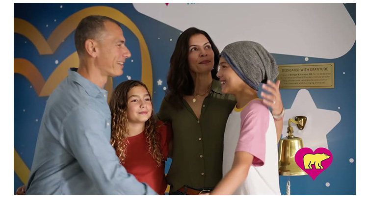 A girl patient hugs her family on the last day of her cancer treatment.
