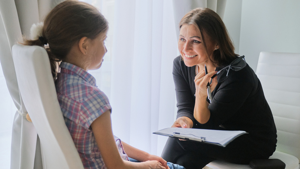 Elementary school teacher testing young girl