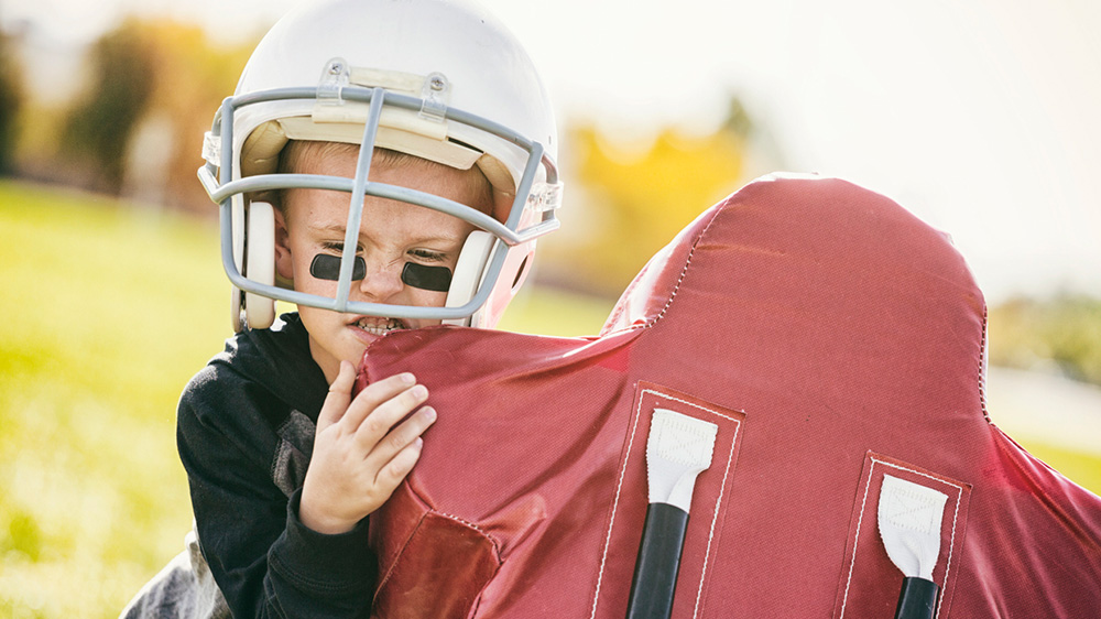 boy during practicing a football tackle