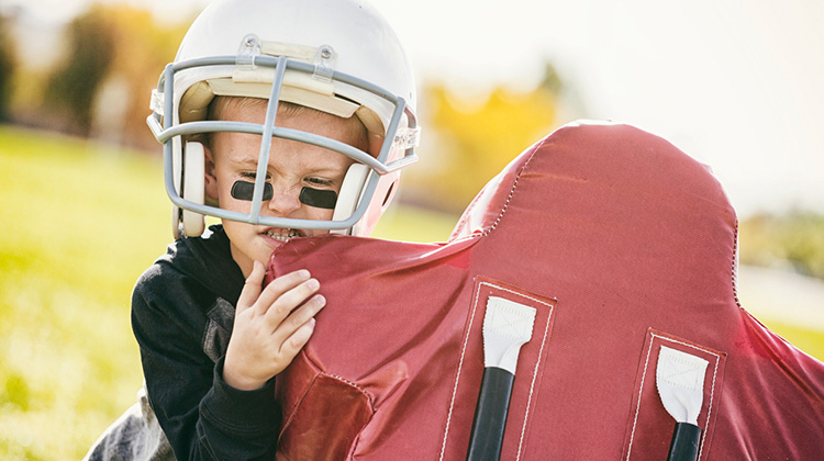 boy practicing football tackle