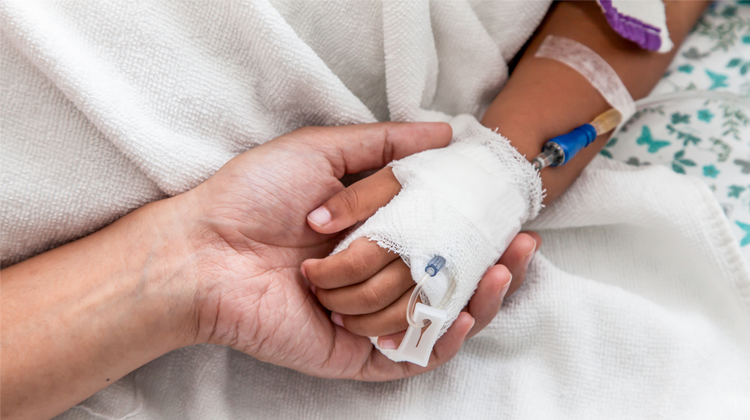 parent and patient holding hands