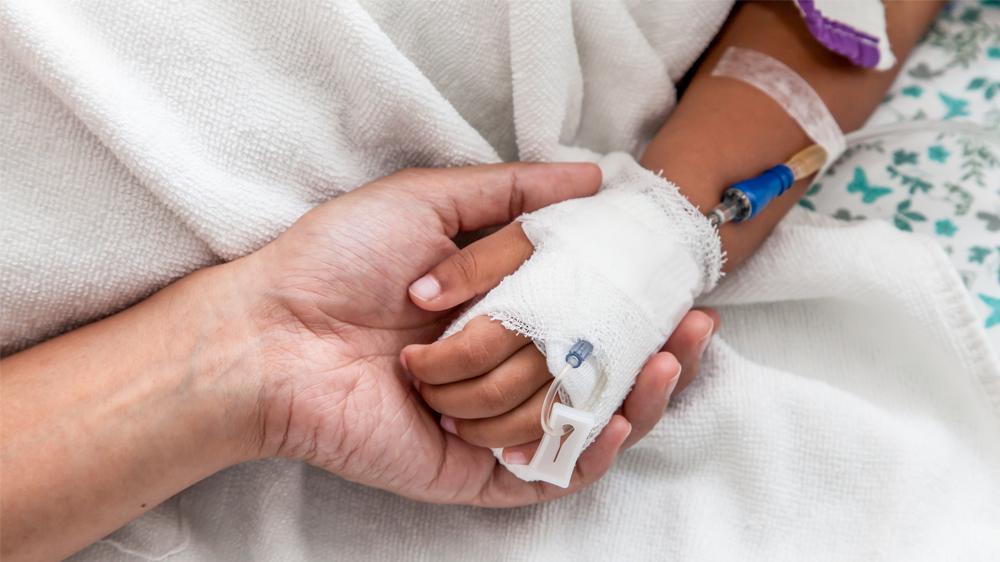 parent and patient holding hands