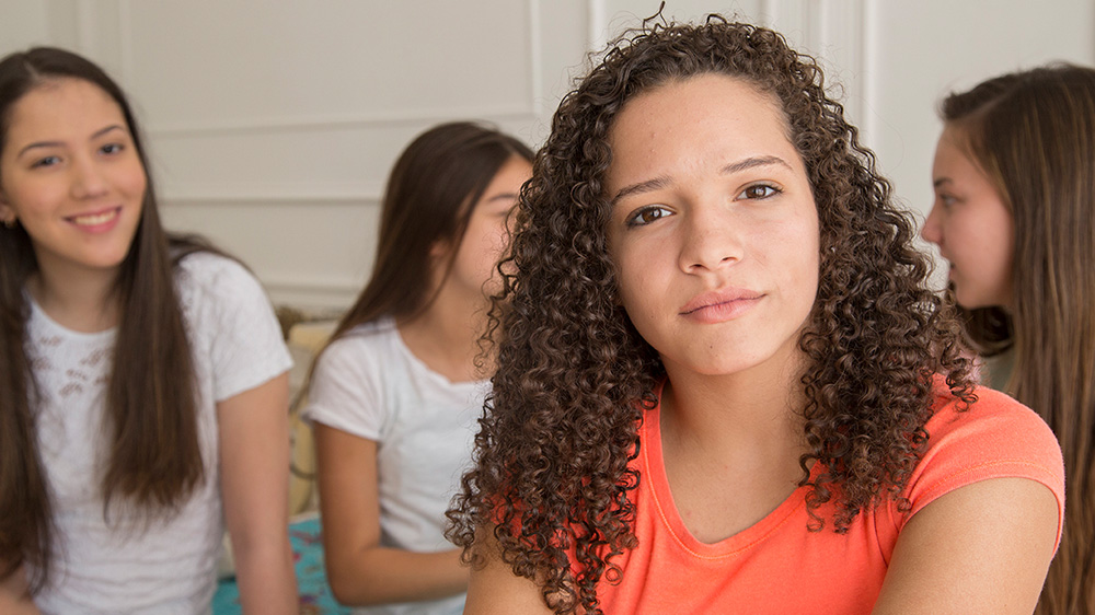 teenage girl with serious expression.