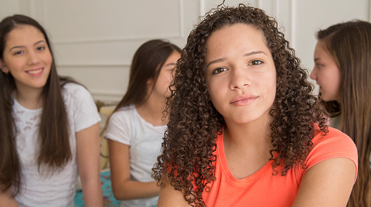 teenage girl with serious expression.