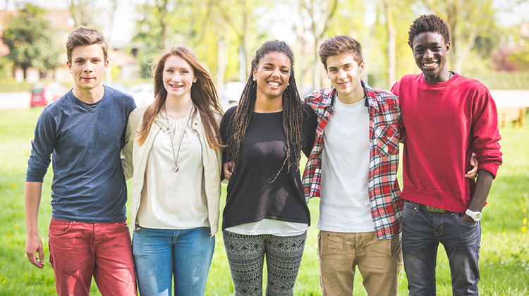 group of teenage boys and girls standing together