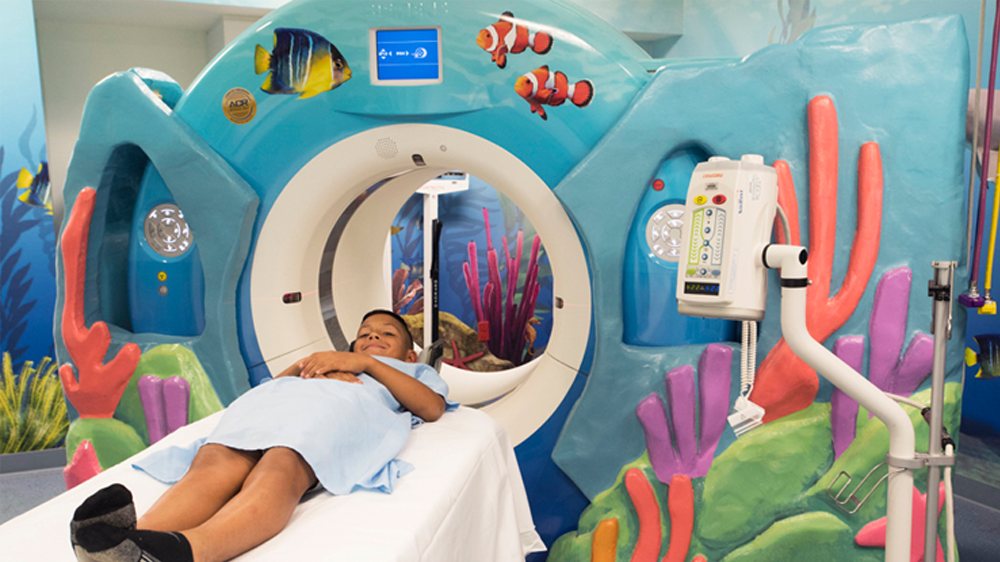 child laying down as he goes inside the MRI machine.