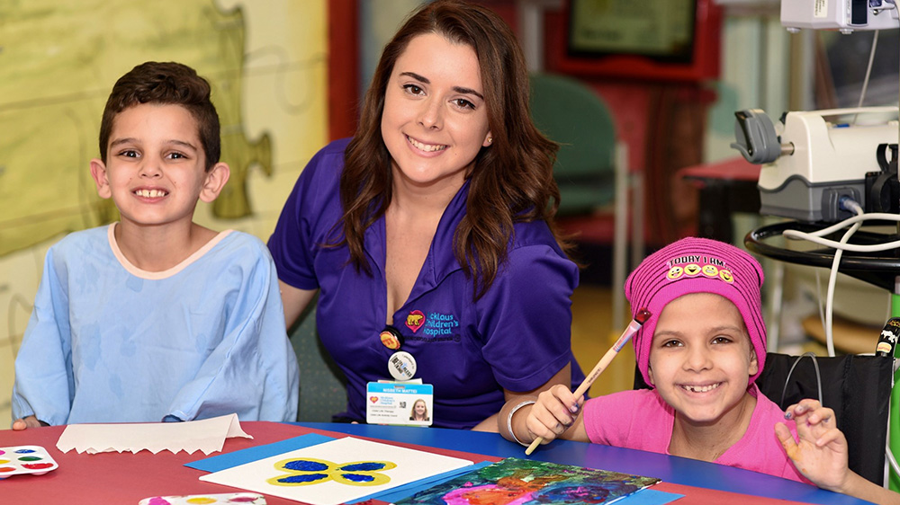 child life specialists engaging in an activity with patients