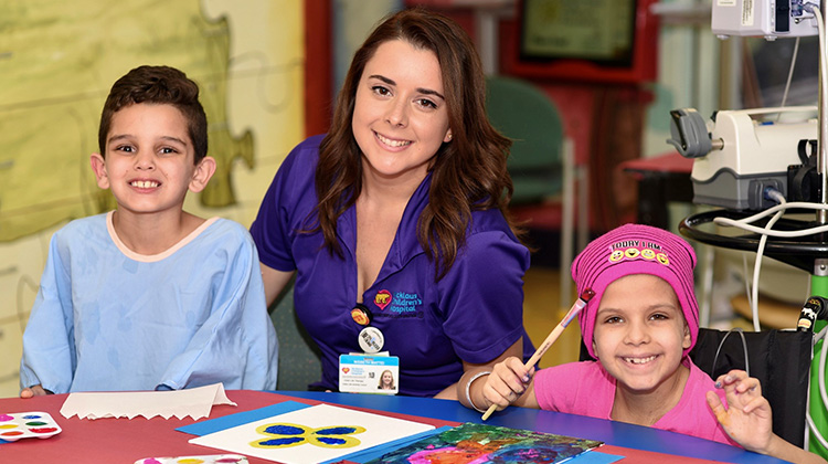 child life specialists engaging in an activity with patients