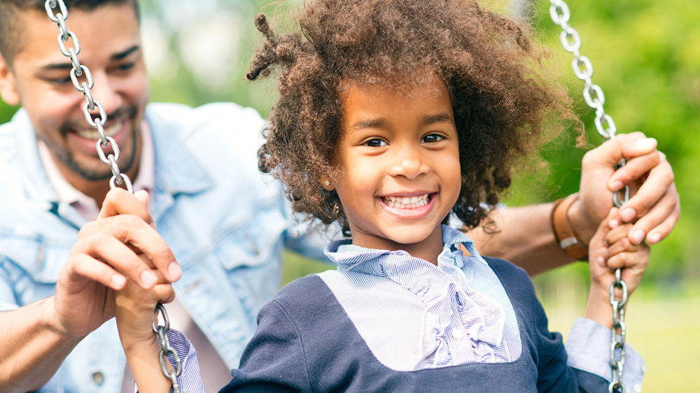 happy african american girl on a swing