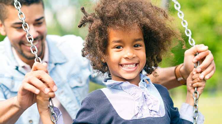 happy african american girl on a swing.